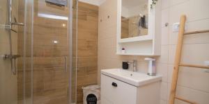 a bathroom with a shower with a toilet and a sink at Pinea in Veli Lošinj +46 photos