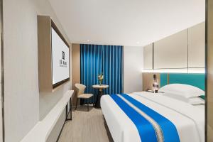 Ένα ή περισσότερα κρεβάτια σε δωμάτιο στο Yinuo Premium Hotel, Guangzhou Zhongshan University Eye Hospital Quzhuang Metro Station Branch