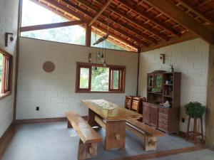 a large room with a wooden table and a bench at São João da Colina Ranch ItamonteMG in Itamonte +40 photos