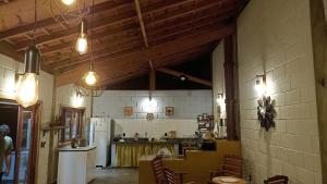 a large room with a kitchen with a refrigerator at São João da Colina Ranch ItamonteMG in Itamonte
