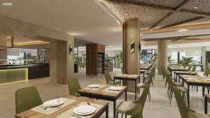 a restaurant with wooden tables and green chairs at Hotel Riu Palace Nautilus - Adults Only in Torremolinos