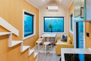 a tiny house with a table and a couch at Dreambox South Kerry in Sneem