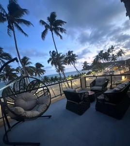 a balcony with chairs and a view of the ocean at N'amaré Pousada in Japaratinga