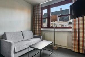 a living room with a couch and a window at Trysil Hotel in Trysil +37 photos