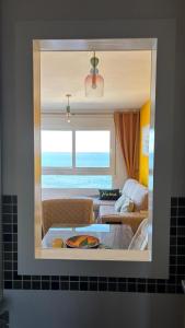 a mirror reflecting a living room with a couch at VENEZIOLA PARADISE, spa & gym in La Manga del Mar Menor