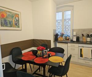 a kitchen with a dining room table and chairs at Art House Olymp in Bamberg