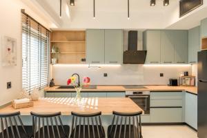 a kitchen with a wooden table and chairs at Kyveli Lake Suite in Kastoria