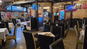 a dining room with tables and chairs in a restaurant at Bistro 29 in Ploieşti