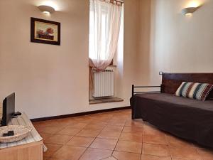 a bedroom with a bed and a window at Appartamenti San Salvatore 1 by Ospitaci in Foligno