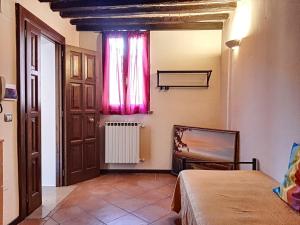 a bedroom with a window and a bed in a room at Appartamenti San Salvatore 1 by Ospitaci in Foligno