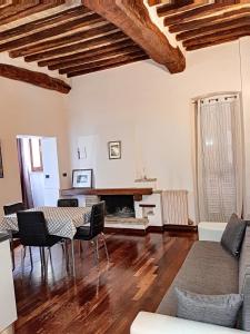 a living room with a table and a fireplace at Appartamenti San Salvatore 1 by Ospitaci in Foligno