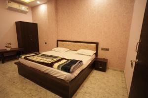 Ένα ή περισσότερα κρεβάτια σε δωμάτιο στο Jiwaji Palace