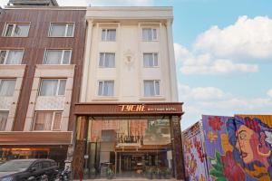 Un edificio alto con un cartel delante. en Hotel Tyche Inn- Luxury in Central Delhi, Near Connaught Place & New Delhi Station, en Nueva Delhi