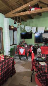 a living room with tables and chairs and a tv at Antica Masseria Il Casone in Candela +60 photos