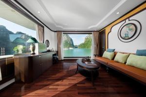 a living room with a couch and a large window at Garden Legend Cruise in Ha Long