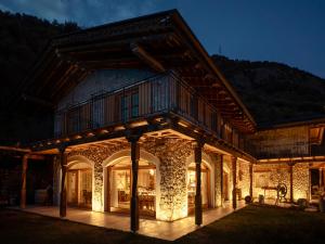 a house in the mountains at night at Agriturismo Maso le 4 stagioni in Arco +23 photos