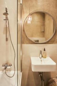 a bathroom with a sink and a mirror at Flamingo Flat - Prague in Prague