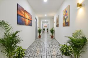 a hallway with potted plants and a tile floor at Via Dream Connect - Narsingi in Hyderabad