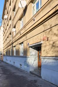 an empty street next to a large building at Flamingo Flat - Prague in Prague