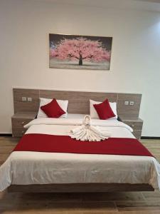 Ένα ή περισσότερα κρεβάτια σε δωμάτιο στο Hôtel Résidence Ngary