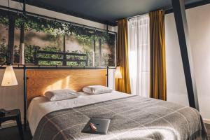 a bedroom with a bed with a laptop on it at Zoom Hotel in Brussels
