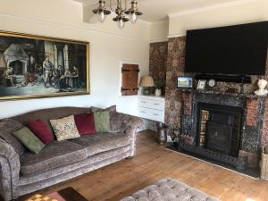 a living room with a couch and a fireplace at St Annes House Double Room 6 in Plymouth