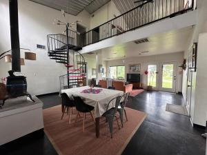 a dining room with a table and chairs in a room at Sunset Oaks Retreat Events, Farm Animals & Views in Saint Jo