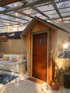 una casa con una porta di legno e un divano di DomosdeMar a 100 mts del mar a Ocean Park