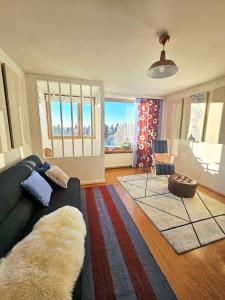 a living room with a couch and a large window at Aalto residence in Rovaniemi