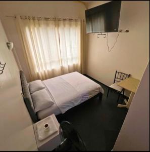 Ένα ή περισσότερα κρεβάτια σε δωμάτιο στο Hostal Las Vegas