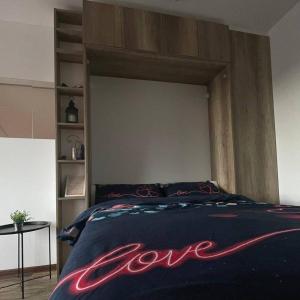 a bedroom with a bed with the word love written on it at Diamond Magic 2 Divcibare in Divčibare