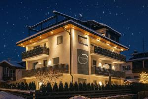 a building with lights on it at night at B&B Obermair in Brunico