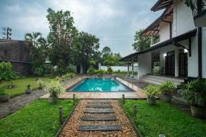 a swimming pool in the yard of a house at Tharan Villa - House in Colombo in Polgasowita