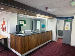 una hall con scrivania e TV di Prime Hotel a Birmingham
