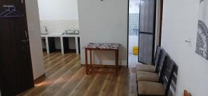a living room with a table and a chair at Budha Garden in Arambol