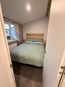 a bedroom with a bed and a window at St Marys View in Whitley Bay