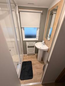 a small bathroom with a sink and a mirror at St Marys View in Whitley Bay