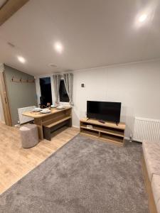 a large living room with a flat screen tv at St Marys View in Whitley Bay