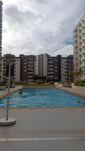 a large swimming pool in a city with buildings at Avida tower 1 L21 staycation condotel rm1002 in Iloilo City