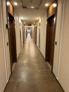a hallway in a building with a long corridor at Bs BnB Luxury Studio Apartment in Dehradun