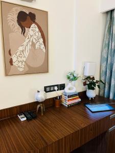 an office with a desk with a picture on the wall at Bs BnB Luxury Studio Apartment in Dehradun