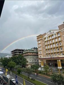 a rainbow in the sky over a city at Bs BnB Luxury Studio Apartment in Dehradun +32 photos