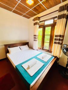 Ένα ή περισσότερα κρεβάτια σε δωμάτιο στο Sigiriya Arecanut Garden +22 φωτογραφίες