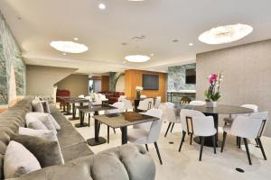 a living room with couches and tables and chairs at Istanbul Taksim Pera Star Hotel - Istiklal Street in Istanbul