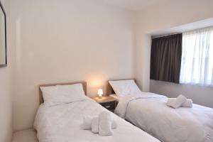 two twin beds in a room with a window at Sea view Spacious 2 bedroom central apartment in Msida +21 photos