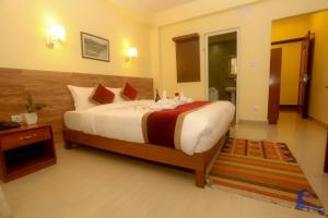 a bedroom with a large bed in a room at Hotel Dream Light in Pokhara
