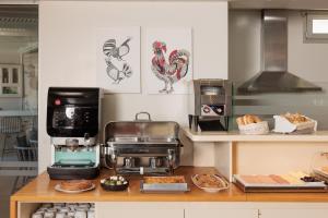 a kitchen with a counter with some food on it at Kouros Art Hotel - Designed for Adults in Stelida +42 photos
