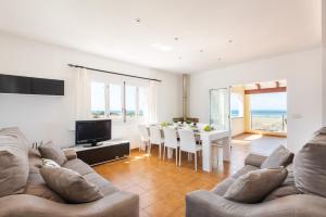 a living room with a couch and a table at Villa Varadero by Escape Home in Alaior