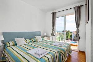 a bedroom with a bed and a large window at Villa Varadero by Escape Home in Alaior +27 photos