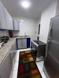 a kitchen with a colorful rug on the floor at Flat in Nag` el-Ramla